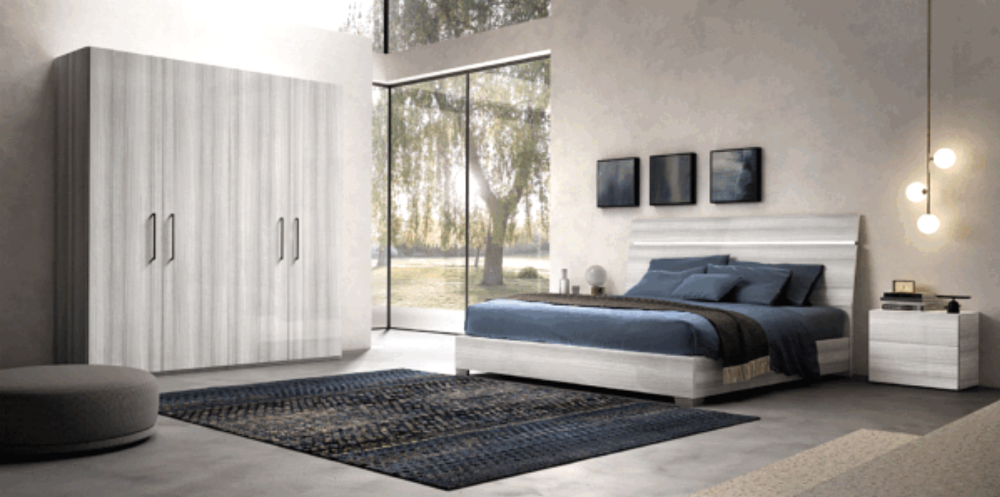 Affordable bedroom furniture in California featuring a bed, nightstand, and wardrobe