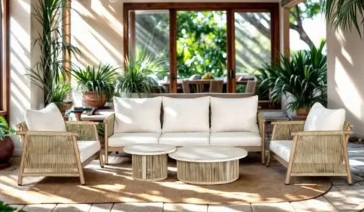 Outdoor furniture in California with a cream sofa, matching chairs, and round coffee tables